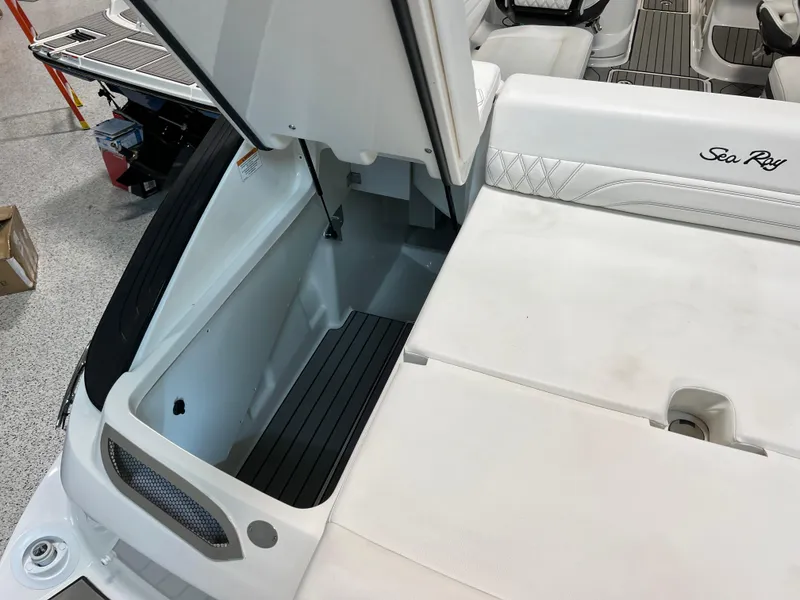 Slide: The Image of 2024 Sea Ray SLX 260 boat storage compartment, open hatch, sleek design. - 27