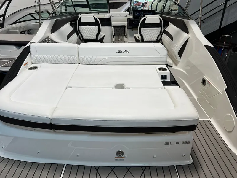 Slide: The Image of 2024 Sea Ray SLX 260 boat interior with white seating and modern design. - 29
