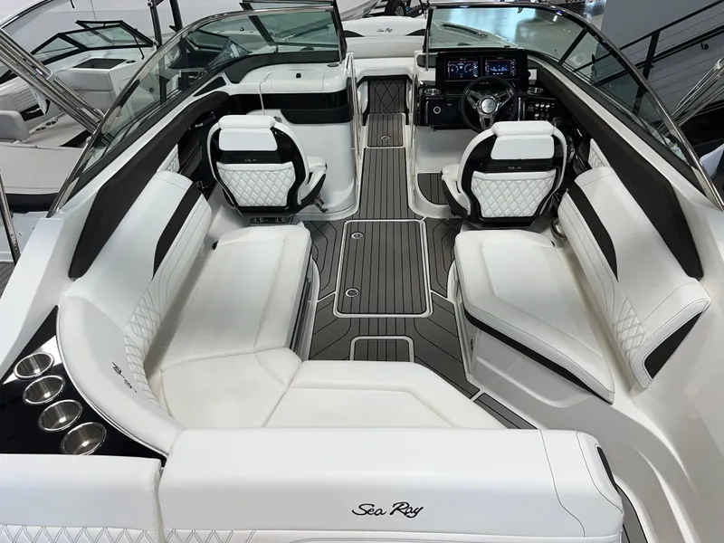 Slide: The Image of 2024 Sea Ray SLX 260 boat interior with luxurious seating and modern dashboard. - 30