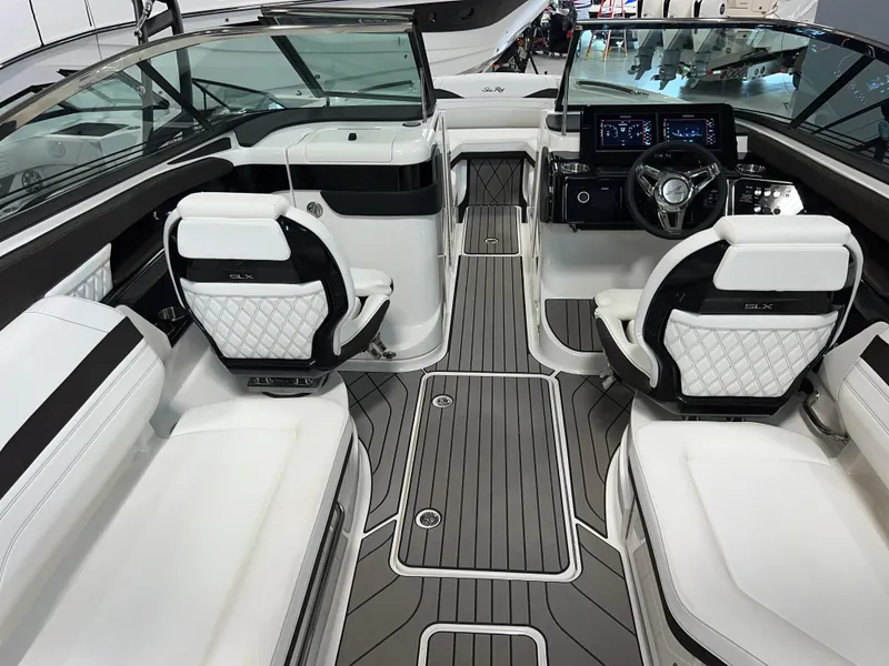 Slide: The Image of 2024 Sea Ray SLX 260 boat interior with modern seating and dashboard design. - 31