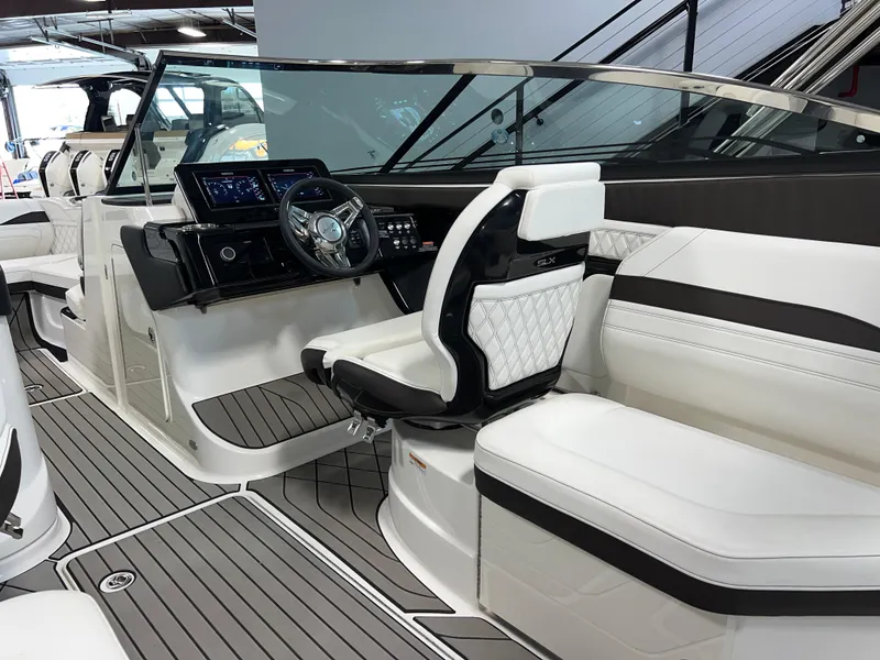 Slide: The Image of 2024 Sea Ray SLX 260 boat interior with modern dashboard and luxurious seating. - 33