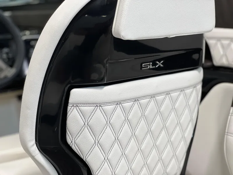 Slide: The Image of 2024 Sea Ray SLX 260 seat with diamond-stitched white upholstery and black trim. - 34
