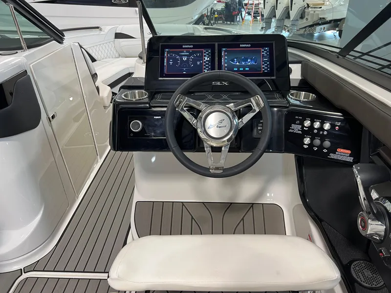 Slide: The Image of 2024 Sea Ray SLX 260 helm with modern controls and sleek design. - 36