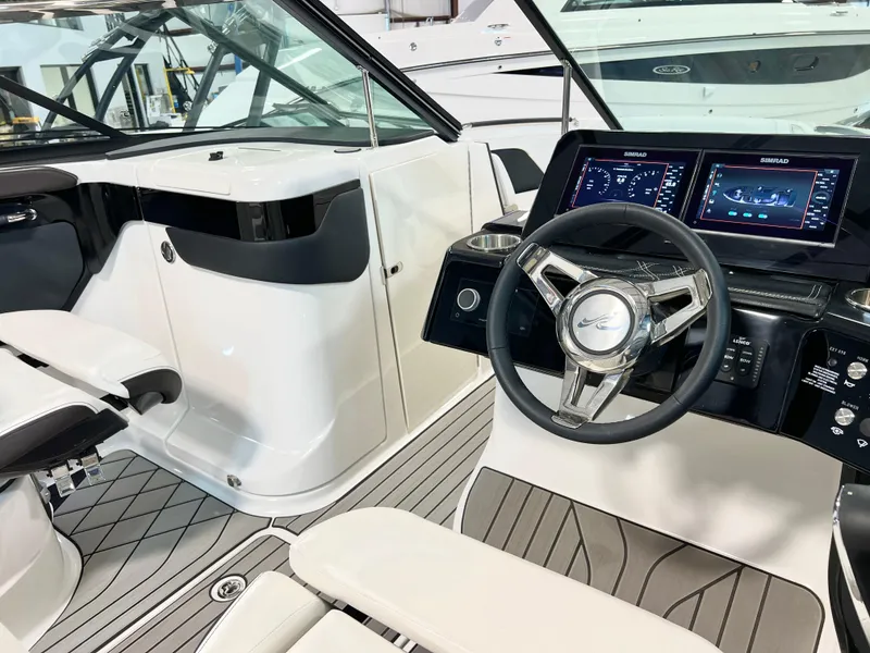 Slide: The Image of 2024 Sea Ray SLX 260 boat interior with modern dashboard and steering wheel. - 37