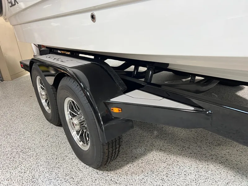Slide: The Image of 2024 Sea Ray SLX 260 boat on a dual-axle trailer in a showroom. - 4
