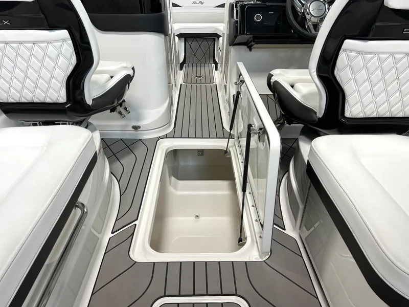 Slide: The Image of 2024 Sea Ray SLX 260 boat interior with open storage compartment and luxurious seating. - 46