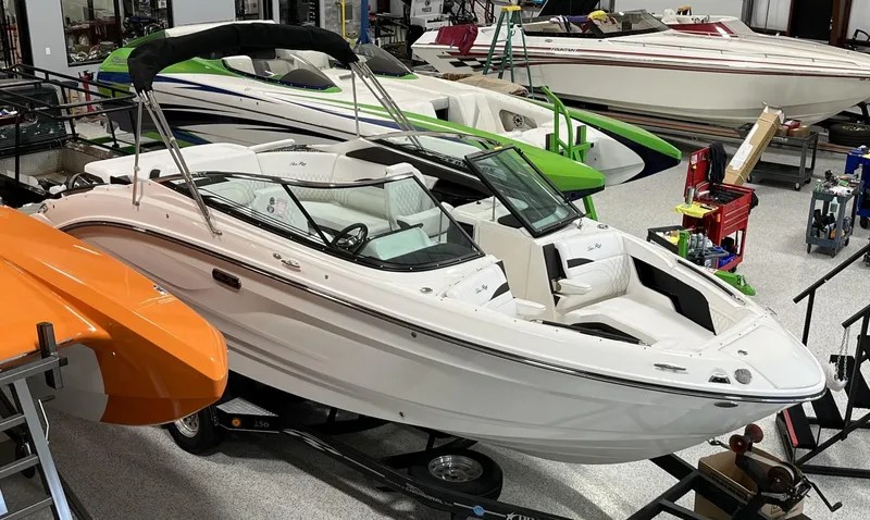 Slide: The Image of 2024 Sea Ray SLX 260 boat in showroom with other boats. - 53