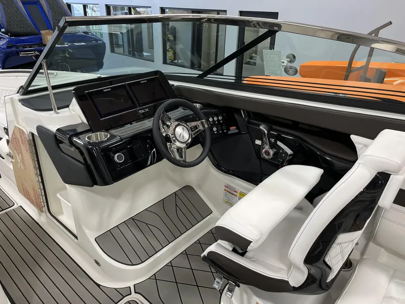 Slide: The Image of 2024 Sea Ray SLX 260 boat cockpit with modern controls and white seating. - 68