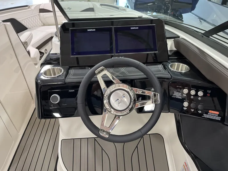 Slide: The Image of 2024 Sea Ray SLX 260 boat dashboard with dual Simrad displays and modern steering wheel. - 69