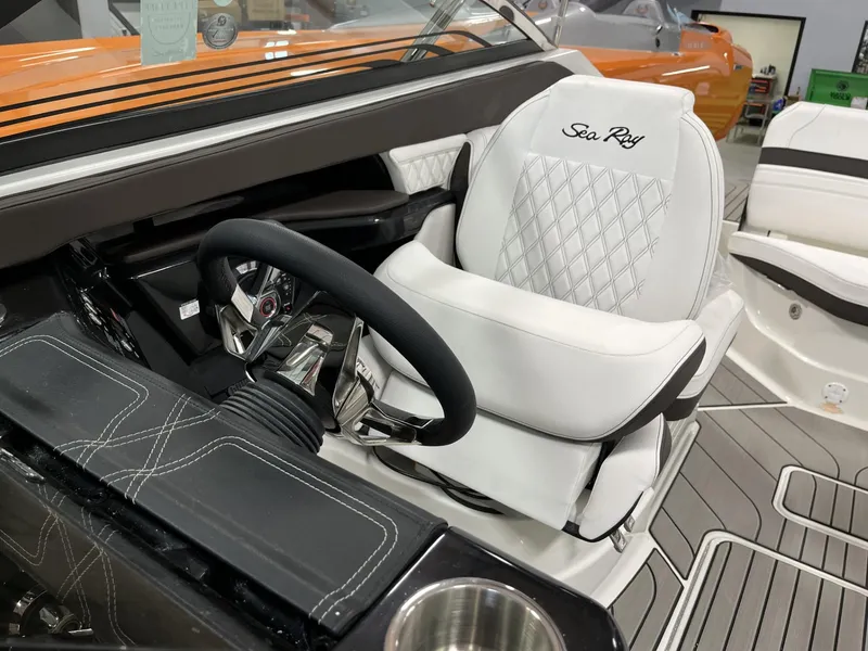 Slide: The Image of 2024 Sea Ray SLX 260 boat interior with white captain's seat and steering wheel. - 71