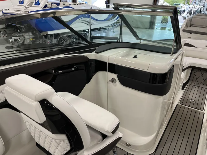 Slide: The Image of 2024 Sea Ray SLX 260 boat interior with white seating and modern dashboard. - 72