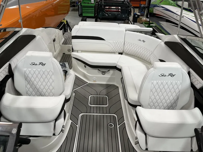 Slide: The Image of 2024 Sea Ray SLX 260 boat interior with white leather seating and diamond stitching. - 73