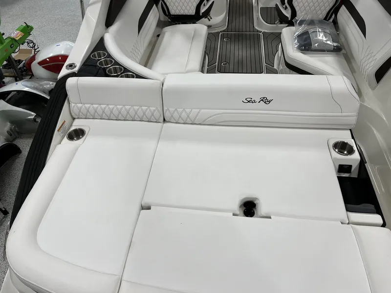 Slide: The Image of 2024 Sea Ray SLX 260 boat interior with white leather seating and cup holders. - 75