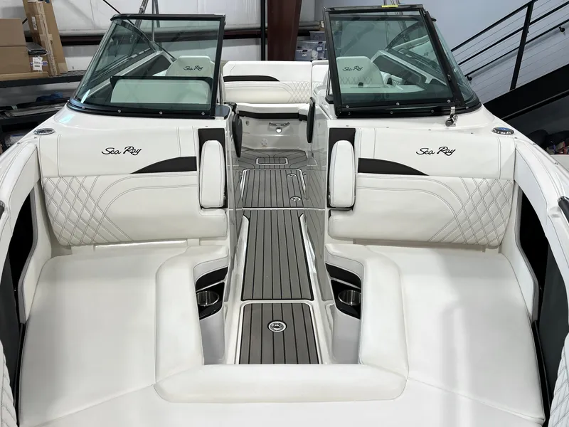 Slide: The Image of 2024 Sea Ray SLX 260 boat interior with white seating and wood accents. - 8