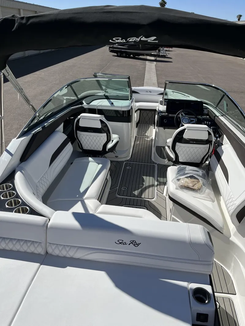 Slide: The Image of 2024 Sea Ray SLX 260 boat interior with white seating and modern dashboard. - 83