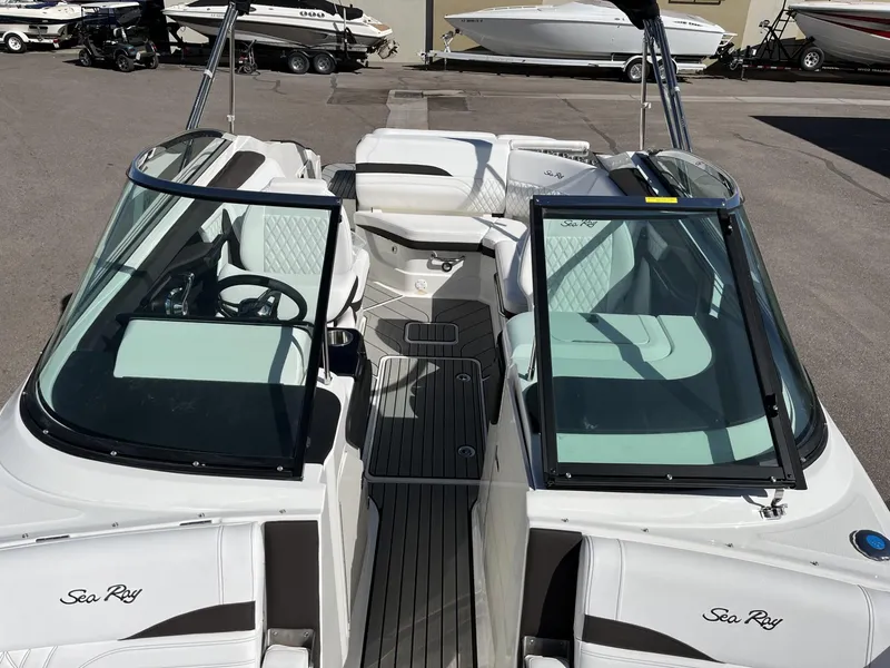 Slide: The Image of 2024 Sea Ray SLX 260 boat interior with white seating and black trim. - 84