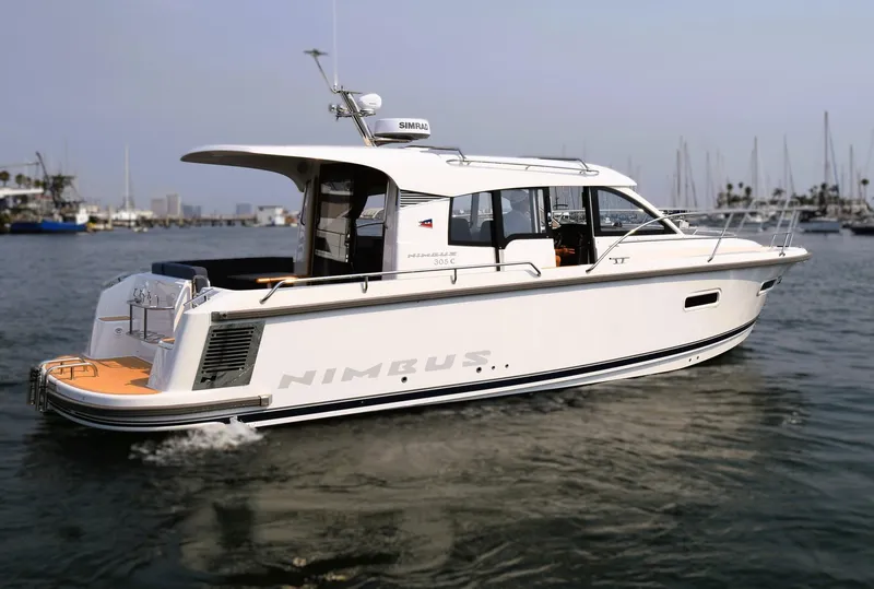 Slide: The Image of 2024 Nimbus 305 Coupe cruising on calm waters, showcasing sleek design and modern features. - 0
