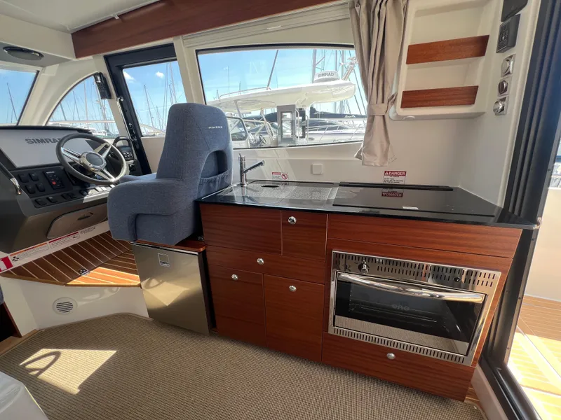 Slide: The Image of Interior of 2024 Nimbus 305 Coupe with modern kitchen and helm station. - 13