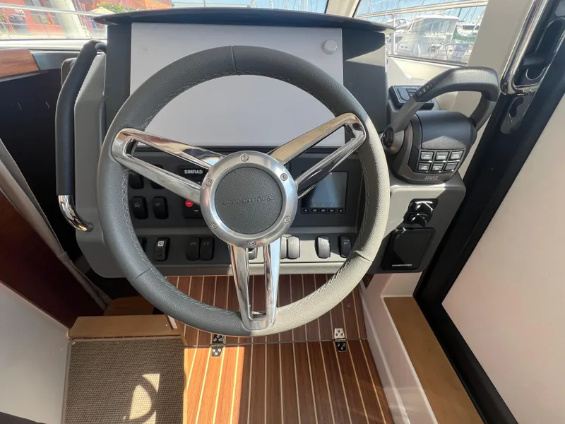 Slide: The Image of Steering wheel of 2024 Nimbus 305 Coupe with modern dashboard controls. - 15