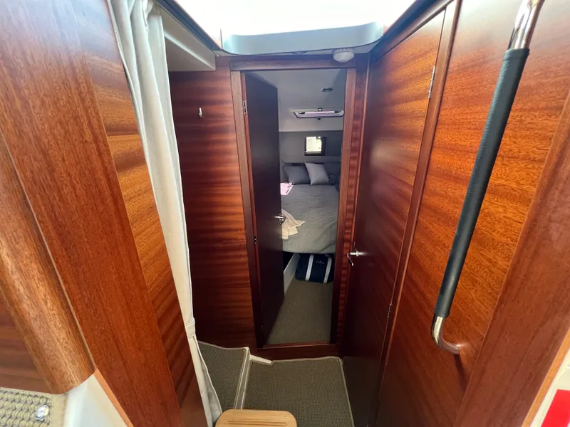 Slide: The Image of Interior view of 2024 Nimbus 305 Coupe, featuring wooden paneling and cozy cabin space. - 18
