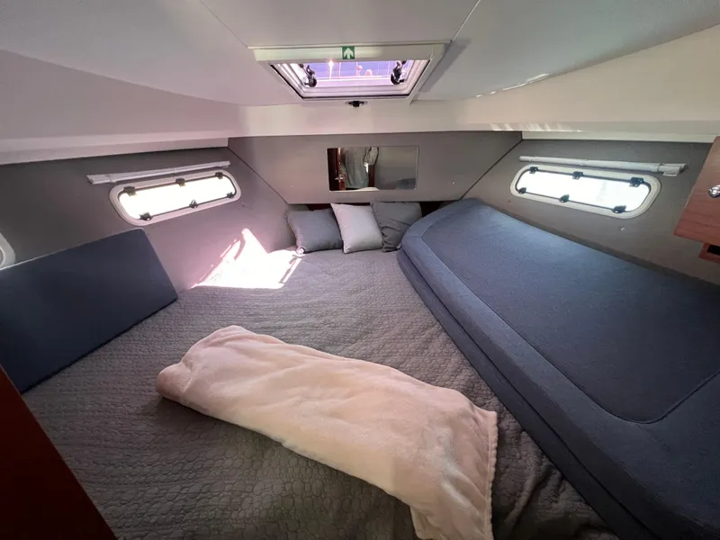 Slide: The Image of Luxurious cabin interior of 2024 Nimbus 305 Coupe with cozy bedding and natural light. - 19