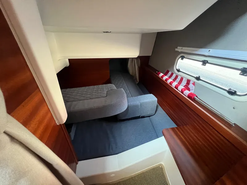 Slide: The Image of Interior cabin of 2024 Nimbus 305 Coupe with cozy seating and wooden accents. - 20