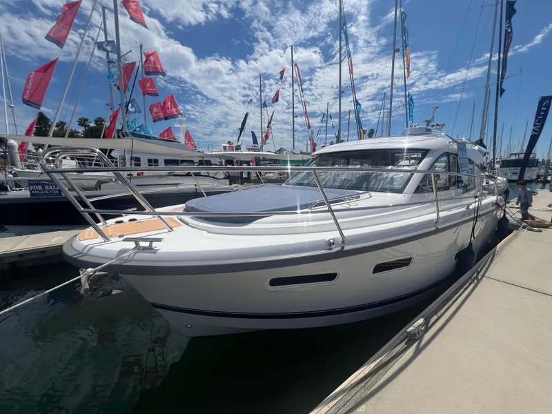 Slide: The Image of 2024 Nimbus 305 Coupe docked at a marina under a sunny sky. - 6