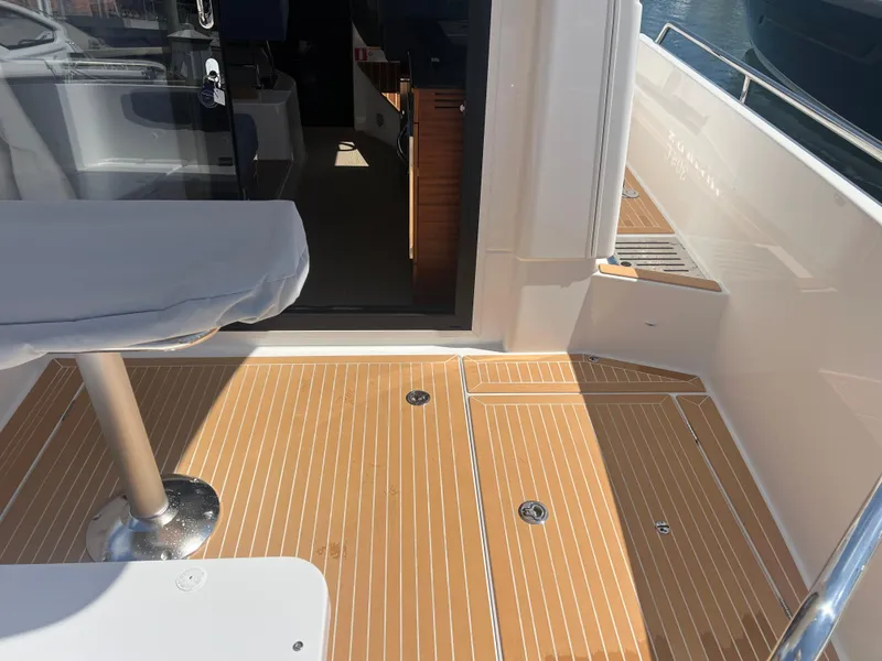 Slide: The Image of Nimbus 305 Coupe 2024 boat deck with wood finish and seating area. - 9