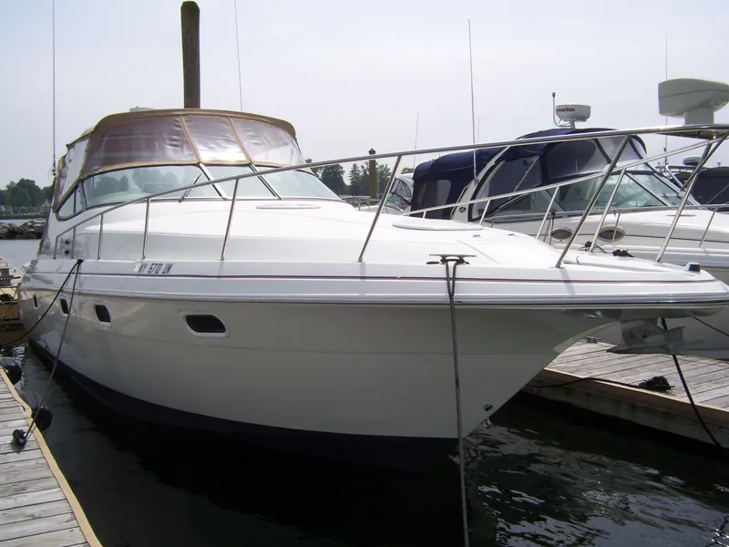 The Image of 1997 Cruisers Yachts 3375 docked, featuring sleek design and spacious deck. - 0