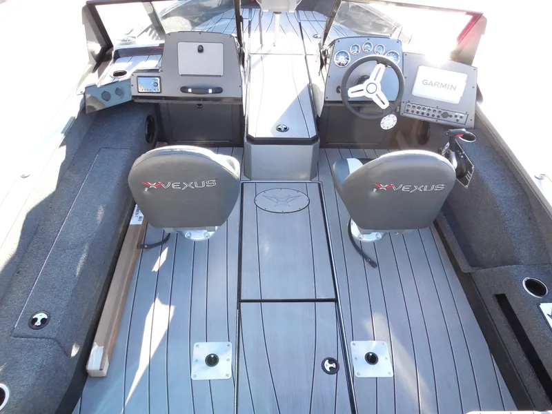 Slide: The Image of 2024 Vexus ADX 180 boat interior with dual seats and Garmin navigation system. - 4