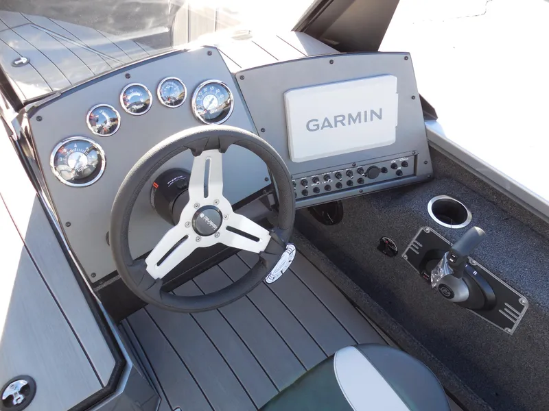 Slide: The Image of 2024 Vexus ADX 180 boat dashboard with Garmin navigation system and steering wheel. - 7