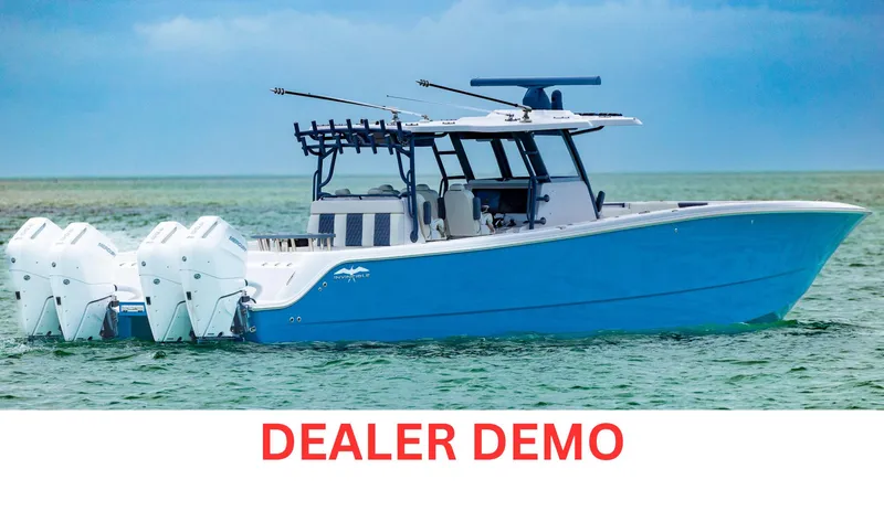 Slide: The Image of 2024 Invincible 46 Catamaran on water, dealer demo model, blue hull, multiple outboard engines. - 0