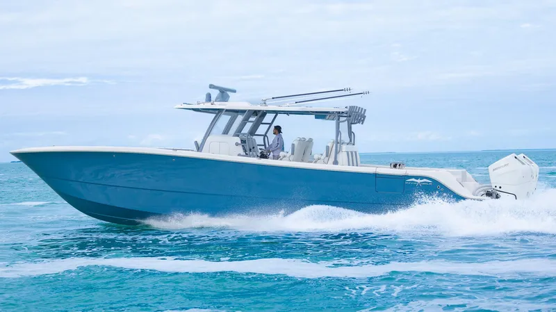 Slide: The Image of 2024 Invincible 46 Catamaran cruising on open water, showcasing sleek design and performance. - 1