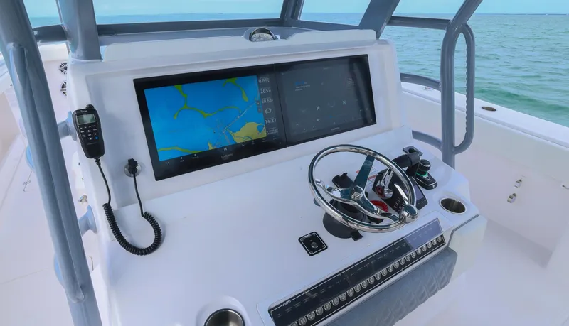 Slide: The Image of 2024 Invincible 46 Catamaran helm with navigation display and steering wheel. - 16