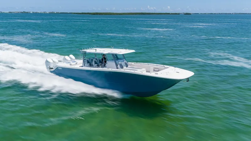 Slide: The Image of 2024 Invincible 46 Catamaran cruising on clear blue ocean waters. - 2