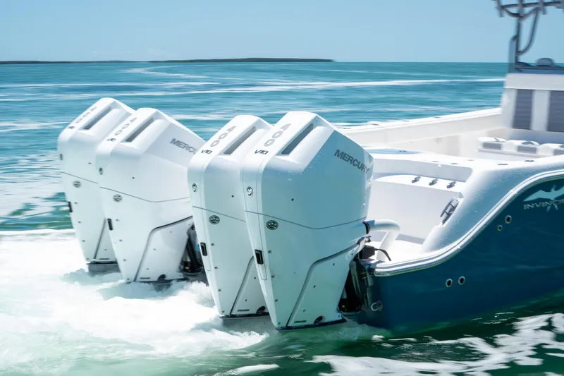 Slide: The Image of 2024 Invincible 46 Catamaran with triple Mercury outboard engines on open water. - 5