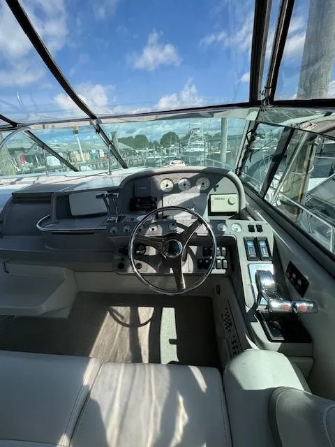 Slide: The Image of Cockpit view of a 2000 Formula 41 PC yacht with steering wheel and control panel. - 11