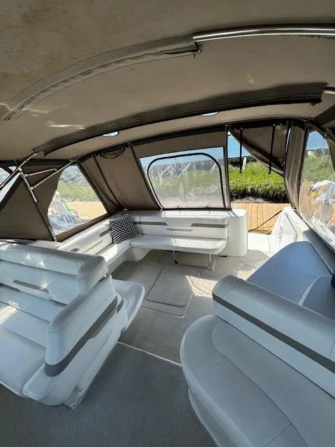 Slide: The Image of Interior of a 2000 Formula 41 PC yacht with white seating and large windows. - 12