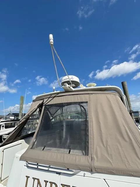 Slide: The Image of 2000 Formula 41 PC boat with Garmin radar at marina under clear blue sky. - 15