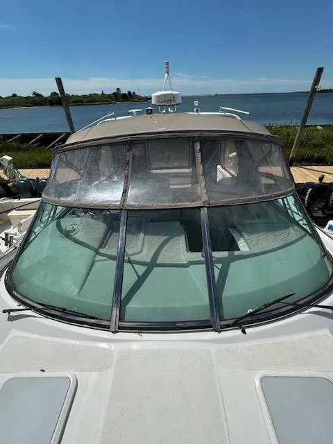 Slide: The Image of 2000 Formula 41 PC boat with a clear windshield docked by the water. - 17