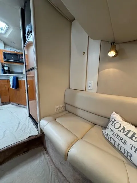 Slide: The Image of Interior of a 2000 Formula 41 PC yacht with beige seating and kitchen area. - 23