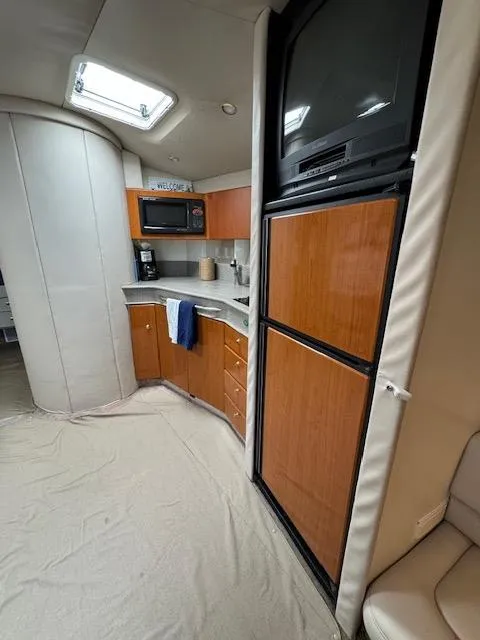 Slide: The Image of 2000 Formula 41 PC yacht interior kitchen with wooden cabinets and appliances. - 24