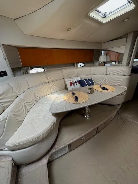 Slide: The Image of Interior of a 2000 Formula 41 PC yacht with a cozy seating area and dining table. - 25
