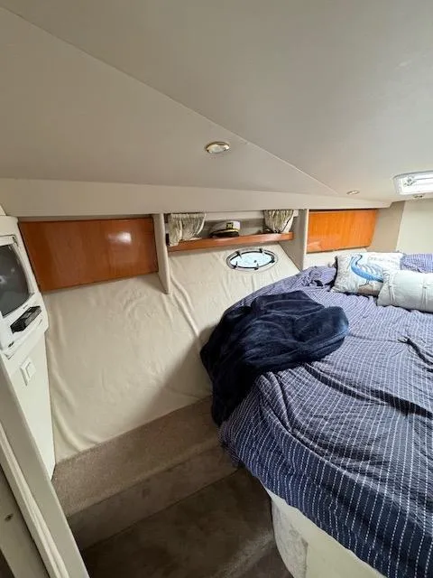 Slide: The Image of Interior cabin of a 2000 Formula 41 PC boat with bed and storage shelves. - 29