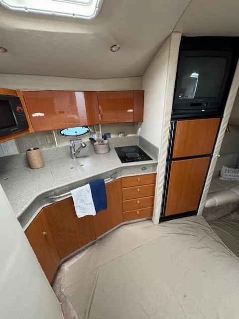 Slide: The Image of 2000 Formula 41 PC yacht kitchen with wooden cabinets and modern appliances. - 34
