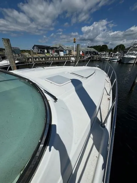 Slide: The Image of 2000 Formula 41 PC yacht docked at a marina under a partly cloudy sky. - 7