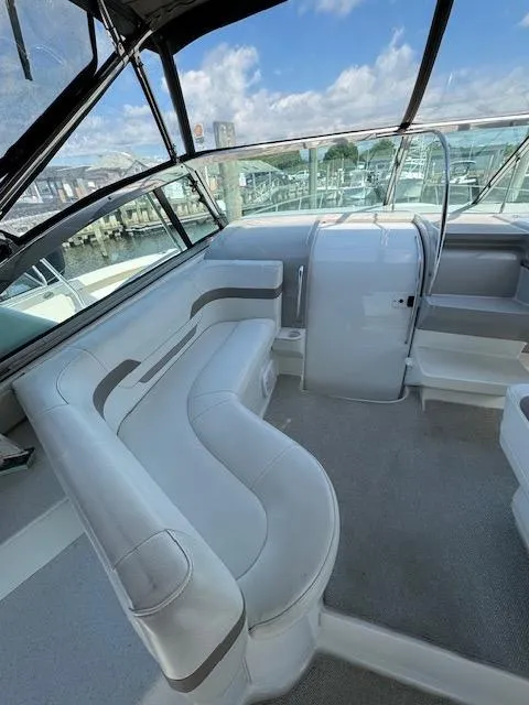 Slide: The Image of Interior of 2000 Formula 41 PC yacht with white seating and marina view. - 8