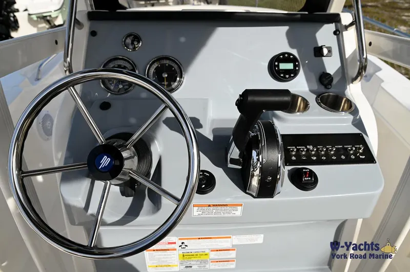 Slide: The Image of 2024 Bayliner T20 boat dashboard with steering wheel and control panel. - 14