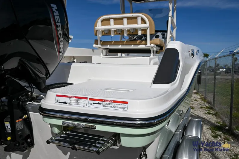 Slide: The Image of 2024 Bayliner T20 boat stern with Mercury outboard motor and swim platform. - 2