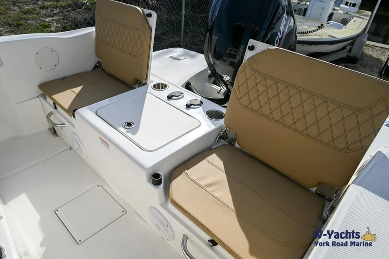 Slide: The Image of 2024 Bayliner T20 boat interior with tan seats and storage compartments. - 21